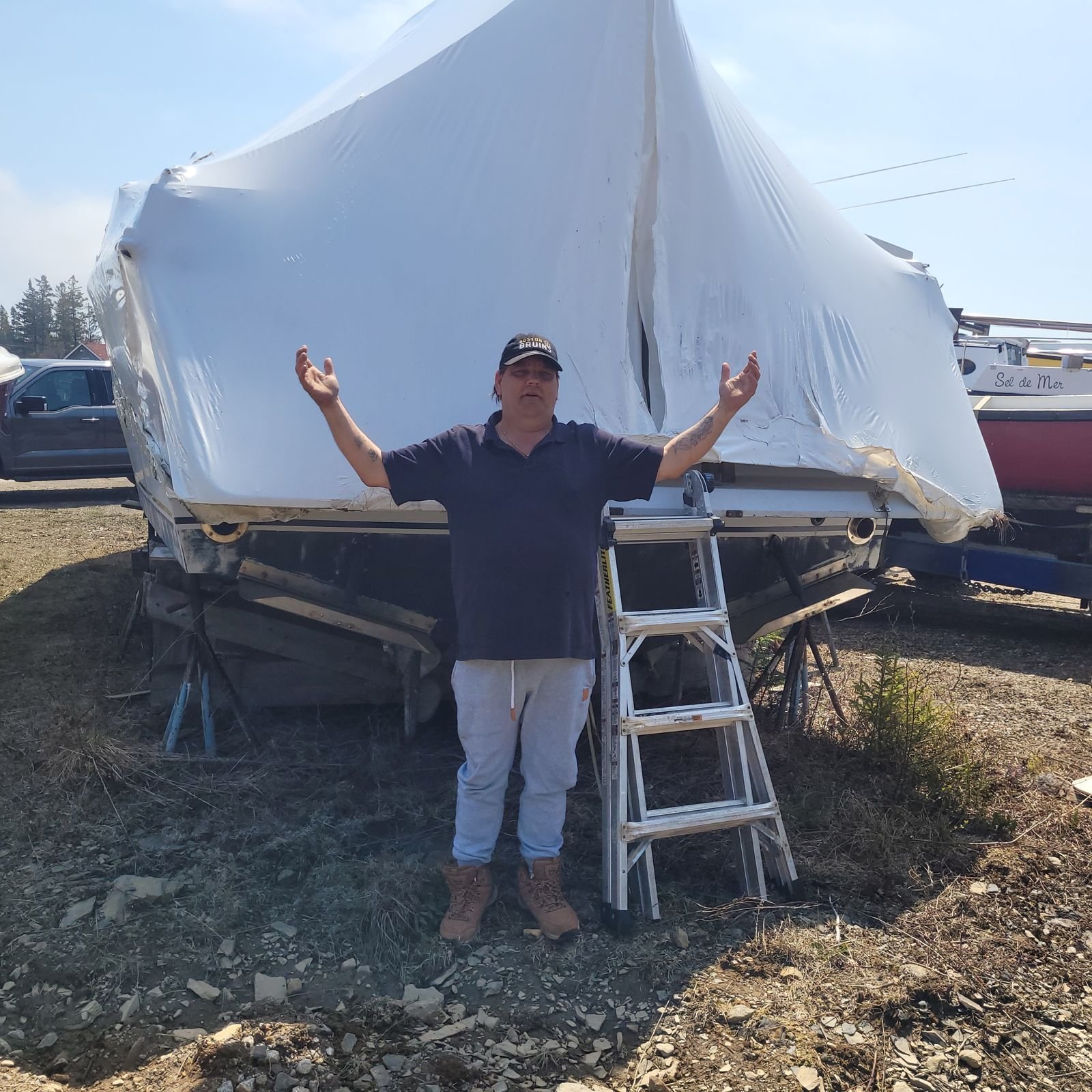 James shrugging in front of the shrink-wrapped Chris-Craft