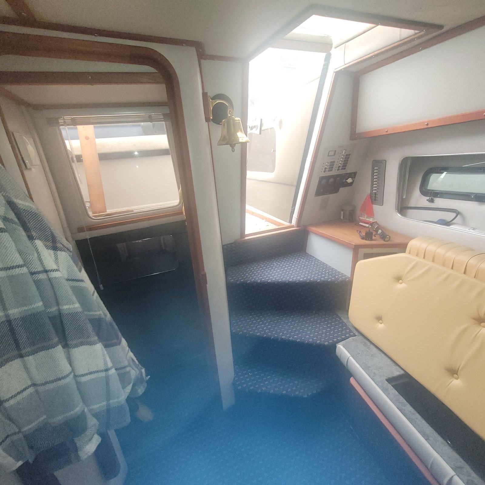 Companionway, brass bell and helm panel